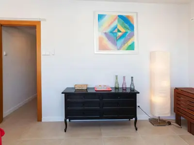 a room with a dresser and a painting on the wall at Apartment Cortijo Barques by Interhome in Sitges