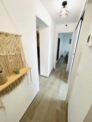 a hallway with white walls and wooden flooring at Apartamento Luna in Montgat