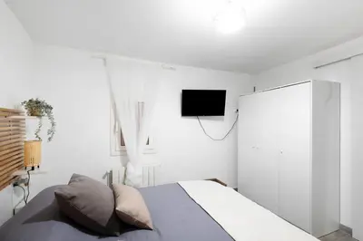 a bedroom with a bed and a tv on the wall at Apartamento Luna in Montgat