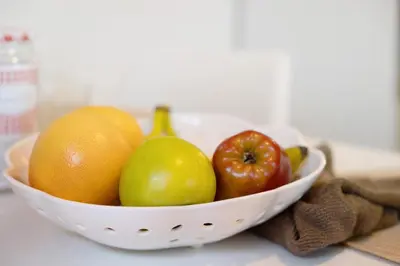 a white bowl of fruit on a table at Apartamento Luna in Montgat