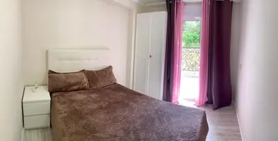 a bedroom with a bed and a window with purple curtains at Puig comfort in Calella
