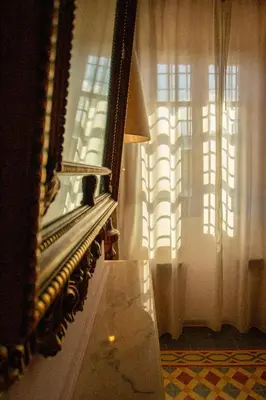 a mirror in a room with a piano and a window at Masía espectacular cerca de Barcelona in Granera