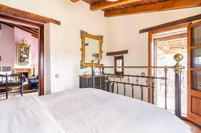 a bedroom with a bed and a mirror at Masía espectacular cerca de Barcelona in Granera