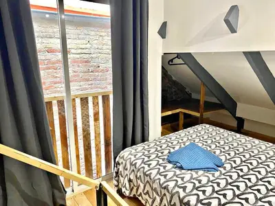 a small bed in a room with a window at Estudio nuevo! Al lado del metro L1 L4 L5 in Barcelona