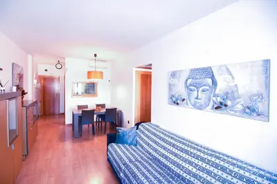 a living room with a bed and a dining room at Touch the Sky in Hospitalet de Llobregat