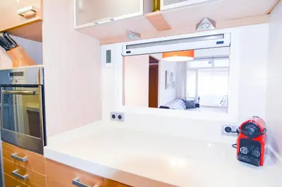 a kitchen with a mirror over a counter at Touch the Sky in Hospitalet de Llobregat