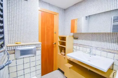 a bathroom with a sink and a mirror at Touch the Sky in Hospitalet de Llobregat