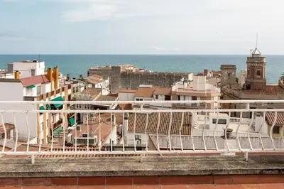a view of a city with the ocean and buildings at Niu d'Oreneta in Canet de Mar