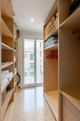a walk in closet with shelves and a window at Niu d'Oreneta in Canet de Mar