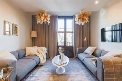 a living room with a couch and a table at En Ville Boutique Apartments Tamarit in Barcelona