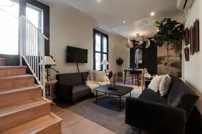 a living room with a couch and a table at En Ville Boutique Apartments Tamarit in Barcelona