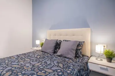 a bedroom with a large bed with two lamps at Dega Sagrada Familia in Barcelona