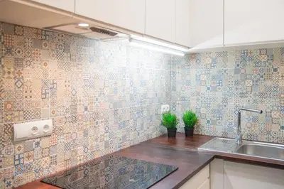 a kitchen with a sink and a tiled wall at Dega Sagrada Familia in Barcelona