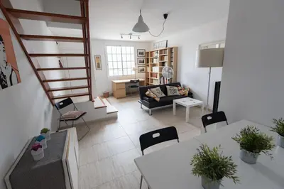 a living room with a couch and a table and chairs at Lovely house in Bellaterra (10 min to UAB) in Cerdanyola del Valles