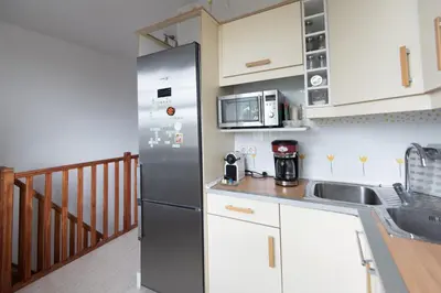 a kitchen with a stainless steel refrigerator and a sink at Lovely house in Bellaterra (10 min to UAB) in Cerdanyola del Valles