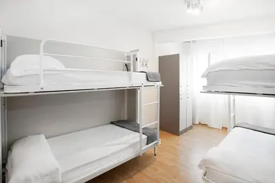 two bunk beds in a room with white walls at Sant Jordi Apartments Sagrada Familia in Barcelona