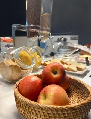 a basket of apples sitting on a table at Sant Jordi Apartments Sagrada Familia in Barcelona