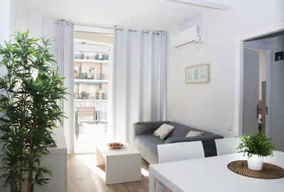 a living room with a couch and a table at Sant Jordi Apartments Sagrada Familia in Barcelona