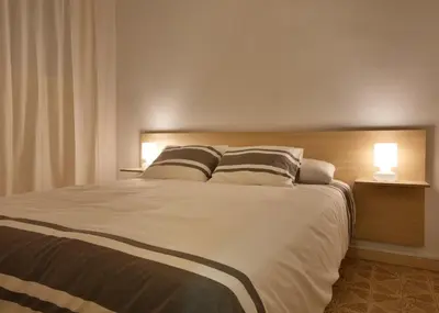 a bedroom with a large bed with two pillows at Apartamentos Olivier in Barcelona
