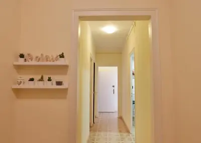 a hallway of a house with yellow walls and shelves at Apartamentos Olivier in Barcelona