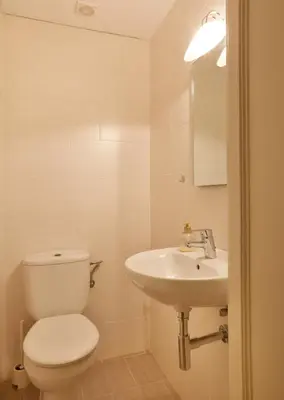 a bathroom with a white toilet and a sink at Apartamentos Olivier in Barcelona