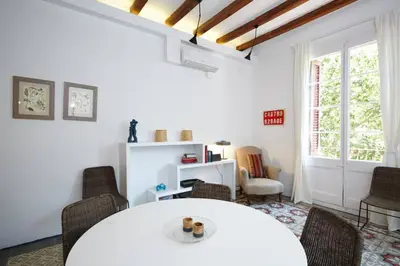 a dining room with a white table and chairs at Beautiful apartment in C/Sepulveda in Barcelona