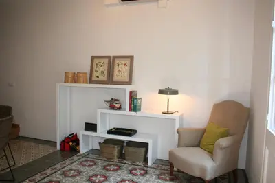 a living room with a chair and a table at Beautiful apartment in C/Sepulveda in Barcelona