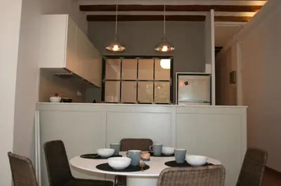 a kitchen with a table and chairs in a room at Beautiful apartment in C/Sepulveda in Barcelona