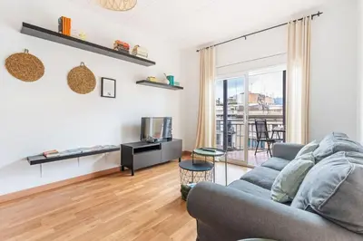 a living room with a couch and a tv at Sunny 3BR for 4 Iconic Terrace Views in Barcelona