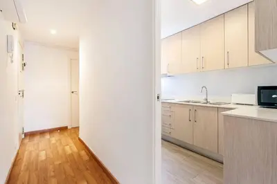 a kitchen with white cabinets and a counter top at Sunny 3BR for 4 Iconic Terrace Views in Barcelona