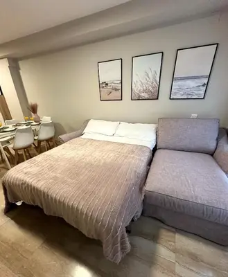 a bedroom with a bed and a table and chairs at DOLCE GAVA - Estación TREN in Gavà