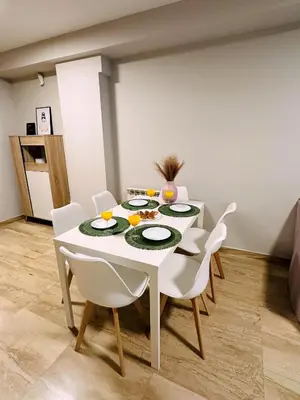 a white dining room table with white chairs and food on it at DOLCE GAVA - Estación TREN in Gavà