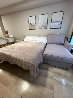 a bedroom with a bed and a table and chairs at DOLCE GAVA - Estación TREN in Gavà