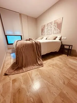 a bedroom with a bed with a blanket on it at DOLCE GAVA - Estación TREN in Gavà