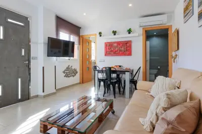 a living room with a couch and a table at Matarolux27 in Mataró