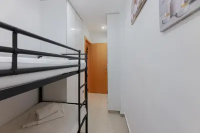 a room with two bunk beds and a hallway at Matarolux27 in Mataró