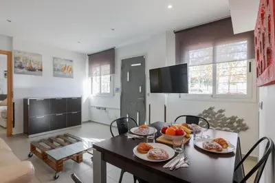 a living room with a table with plates of food on it at Matarolux27 in Mataró