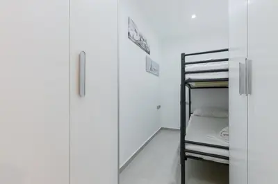 a bunk room with a bunk bed and a ladder at Matarolux27 in Mataró