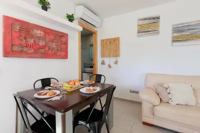 a living room with a table and a couch at Matarolux27 in Mataró