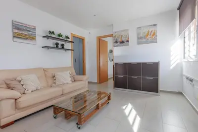 a living room with a couch and a coffee table at Matarolux27 in Mataró