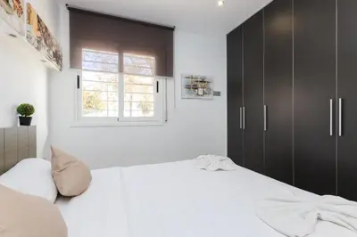 a bedroom with a large bed and a window at Matarolux27 in Mataró