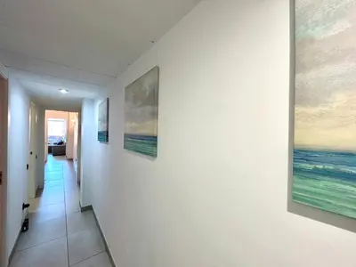 a hallway with two paintings on the wall at Apartment Sagrera in Barcelona