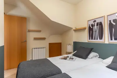 a bedroom with a bed with a book on it at AB Sagrada Familia - Sant Pau in Barcelona