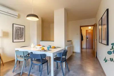 a kitchen and dining room with a white table and chairs at AB Sagrada Familia - Sant Pau in Barcelona