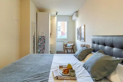 a bedroom with a bed with a tray of food on it at AB Sagrada Familia - Sant Pau in Barcelona
