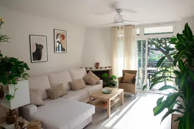 a living room with a white couch and a table at Wonderful apartment in Gavà. Barcelona in Gavà