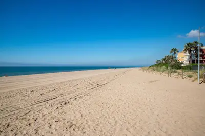 a beach with footprints in the sand and the ocean at Wonderful apartment in Gavà. Barcelona in Gavà