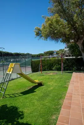 a playground with a yellow slide in a park at Wonderful apartment in Gavà. Barcelona in Gavà