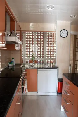a kitchen with a counter and a clock on the wall at Wonderful apartment in Gavà. Barcelona in Gavà