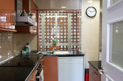 a kitchen with a sink and a clock on the wall at Wonderful apartment in Gavà. Barcelona in Gavà